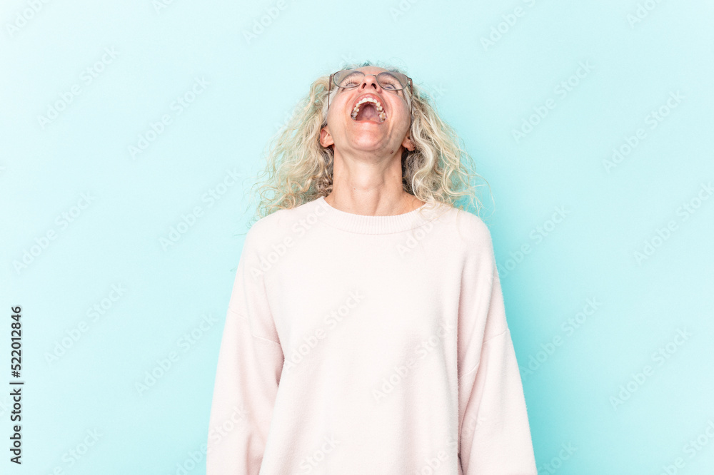 Middle age caucasian woman isolated on blue background relaxed and happy laughing, neck stretched showing teeth. Middle age caucasian woman isolated on blue background relaxed and happy laughing, neck stretched showing teeth.