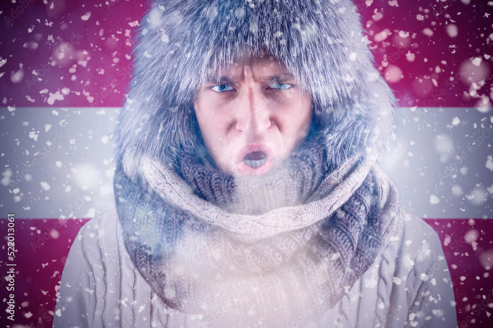Isolate. Cold weather. Bask. A man in a fur hat and scarf warms his hands with his mouth. It's winter time Isolate. Cold weather. Bask. A man in a fur hat and scarf warms his hands with his mouth. It's winter time