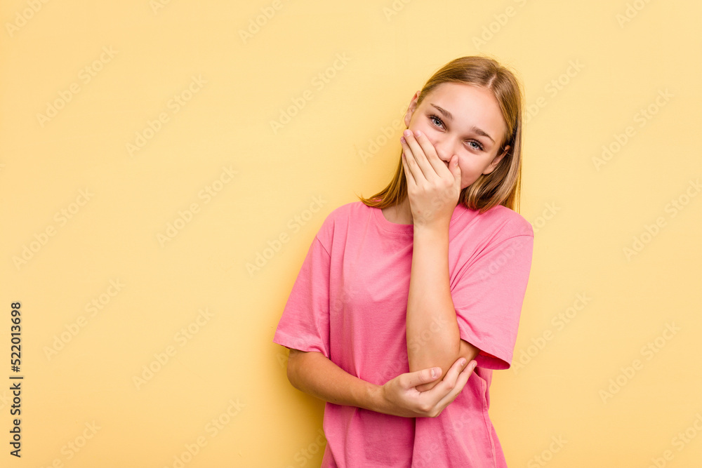Young caucasian girl isolated on yellow background laughing happy, carefree, natural emotion. Young caucasian girl isolated on yellow background laughing happy, carefree, natural emotion.