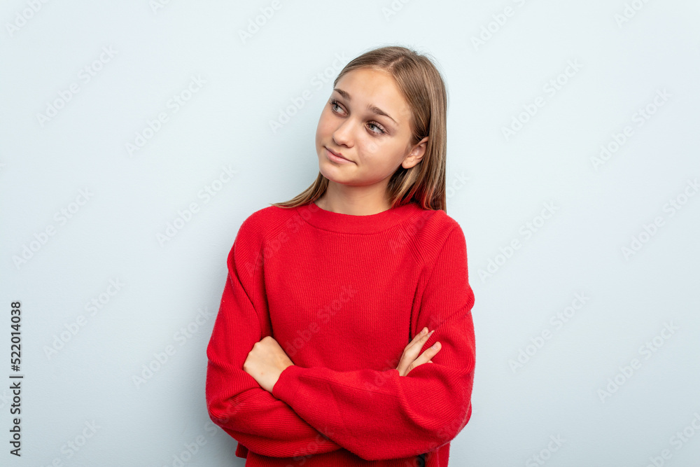 Young caucasian girl isolated on blue background dreaming of achieving goals and purposes Young caucasian girl isolated on blue background dreaming of achieving goals and purposes