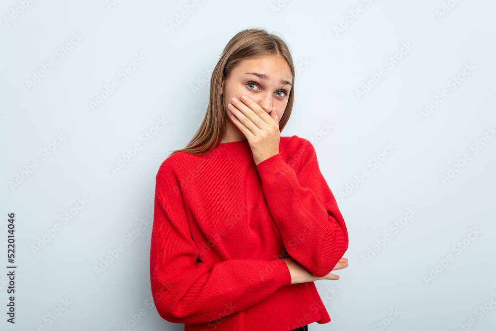 Young caucasian girl isolated on blue background scared and afraid. Young caucasian girl isolated on blue background scared and afraid.