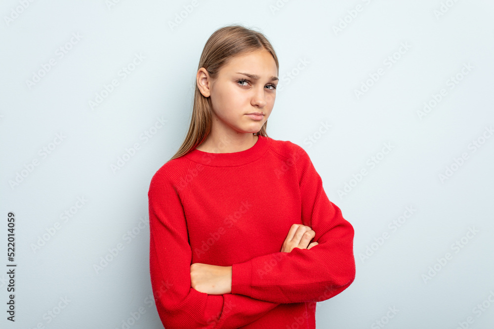 Young caucasian girl isolated on blue background suspicious, uncertain, examining you. Young caucasian girl isolated on blue background suspicious, uncertain, examining you.