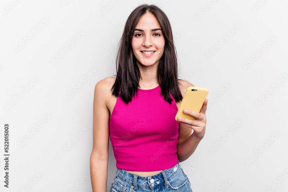 Young caucasian woman holding mobile phone isolated on white background happy, smiling and cheerful. Young caucasian woman holding mobile phone isolated on white background happy, smiling and cheerful.