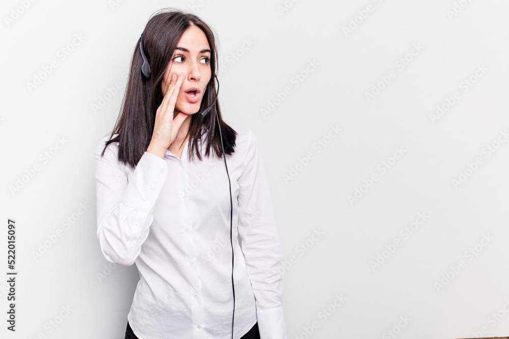 Telemarketer caucasian woman working with a headset isolated on white background is saying a secret hot braking news and looking aside Telemarketer caucasian woman working with a headset isolated on white background is saying a secret hot braking news and looking aside