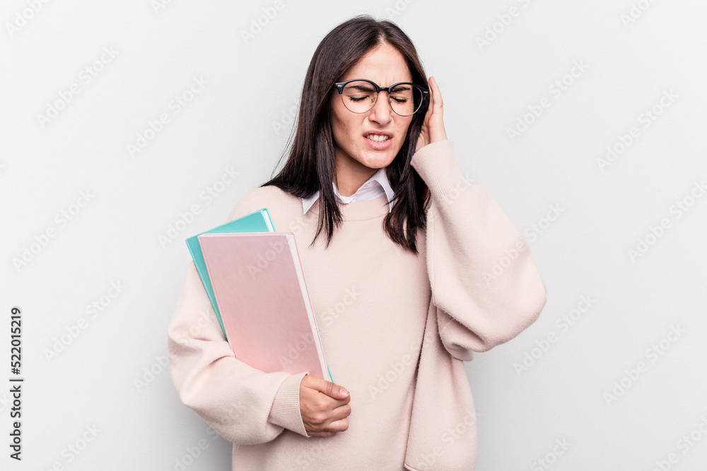 Young student caucasian woman isolated on white background covering ears with hands. Young student caucasian woman isolated on white background covering ears with hands.
