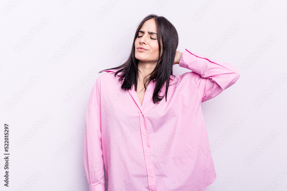 Fototapeta premium Young caucasian woman isolated on pink background tired and very sleepy keeping hand on head.