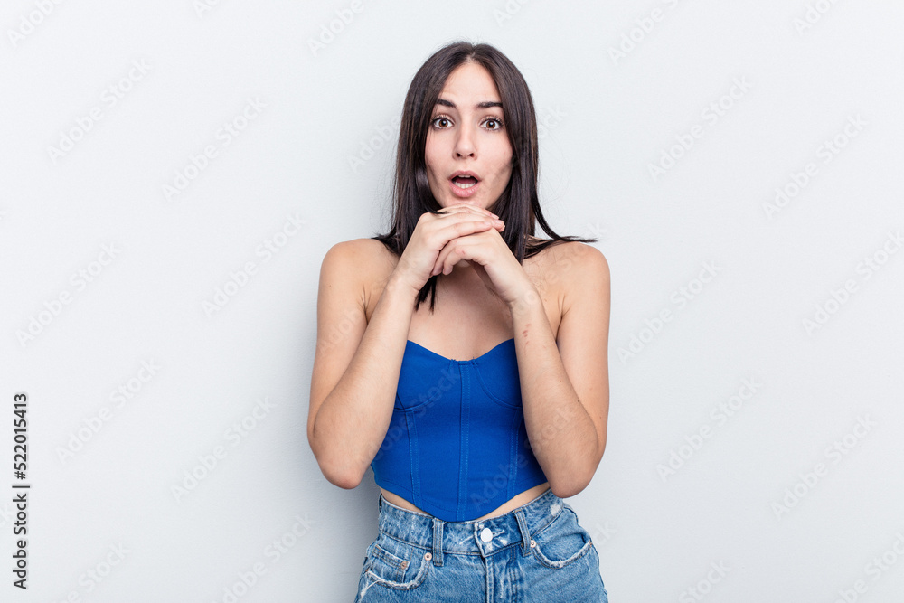Young caucasian woman isolated on white background praying for luck, amazed and opening mouth looking to front. Young caucasian woman isolated on white background praying for luck, amazed and opening mouth looking to front.