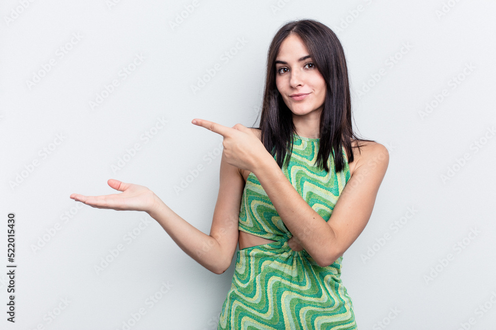 Young caucasian woman isolated on white background excited holding a copy space on palm. Young caucasian woman isolated on white background excited holding a copy space on palm.