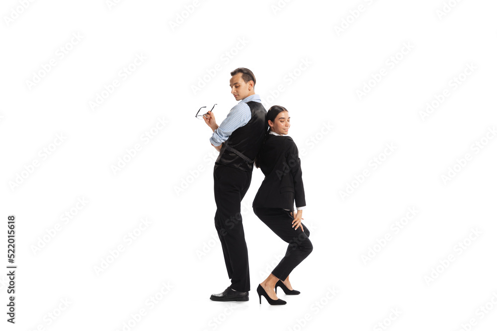 Portrait of two business people, man and woman posing isolated over white background. Office romance