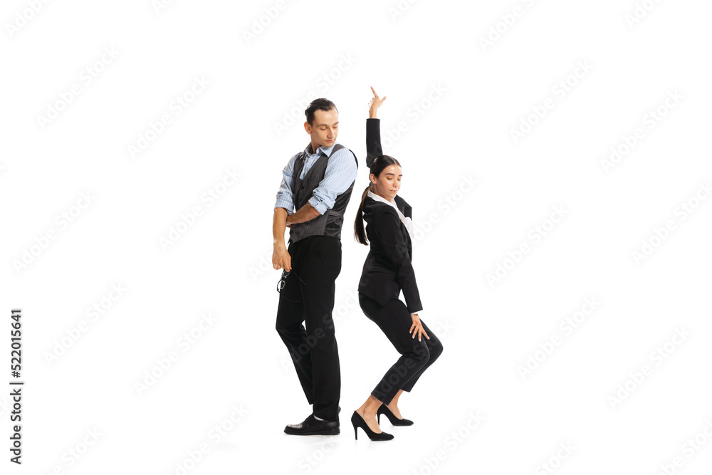 Portrait of two office workers, woman dancing near staring man isolated on white background. Office relationship Portrait of two office workers, woman dancing near staring man isolated on white background. Office relationship