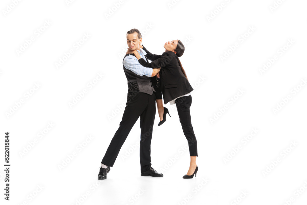 Portrait of young woman, employee trying to kiss office manager isolated on white background. Relationship Portrait of young woman, employee trying to kiss office manager isolated on white background. Relationship
