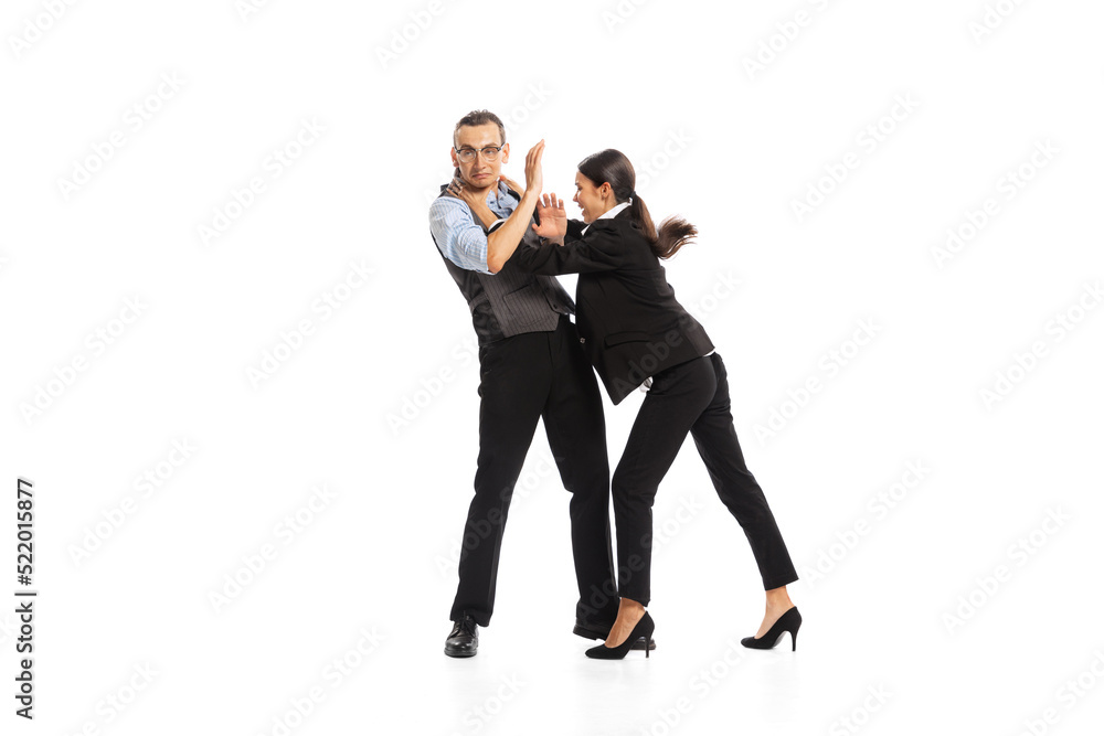 Portrait of man and woman, office managers, employees fighting with each other isolated on white background Portrait of man and woman, office managers, employees fighting with each other isolated on white background