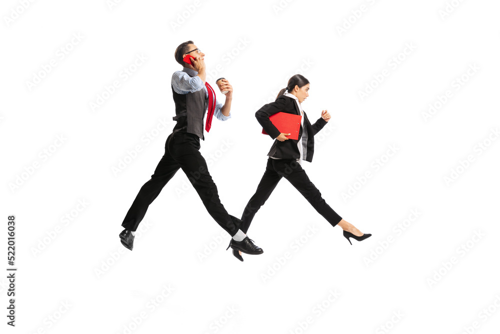 Portrait of man and woman, business people working on their way, posing in action isolated over white background
