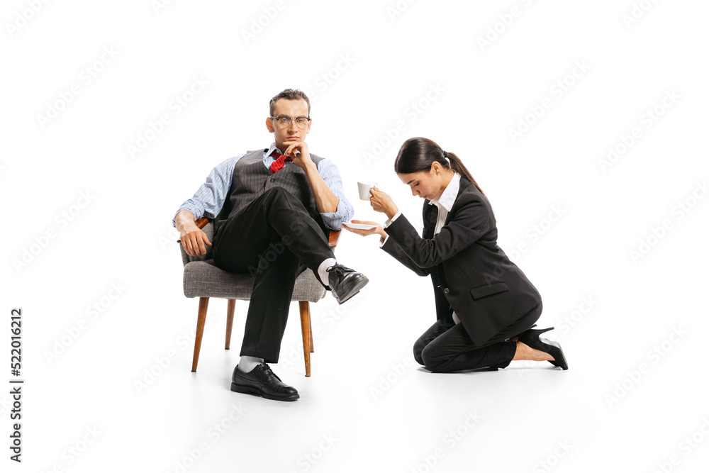 Portrait of man, office manager and woman, employee isolated over white studio background. Secretary serving coffee to boss Portrait of man, office manager and woman, employee isolated over white studio background. Secretary serving coffee to boss