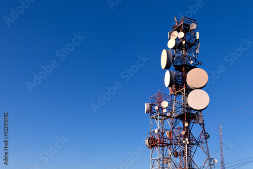 Transmission and telecommunications towers with blue sky in the background