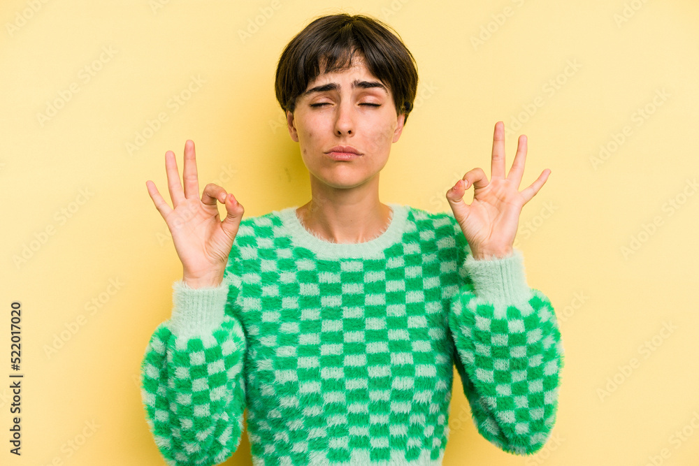 Young caucasian woman with a short hair cut isolated relaxes after hard working day, she is performing yoga. Young caucasian woman with a short hair cut isolated relaxes after hard working day, she is performing yoga.
