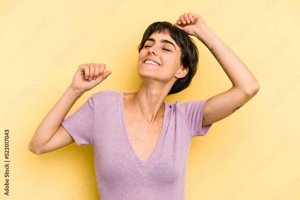Young caucasian woman with a short hair cut isolated celebrating a special day, jumps and raise arms with energy. Young caucasian woman with a short hair cut isolated celebrating a special day, jumps and raise arms with energy.
