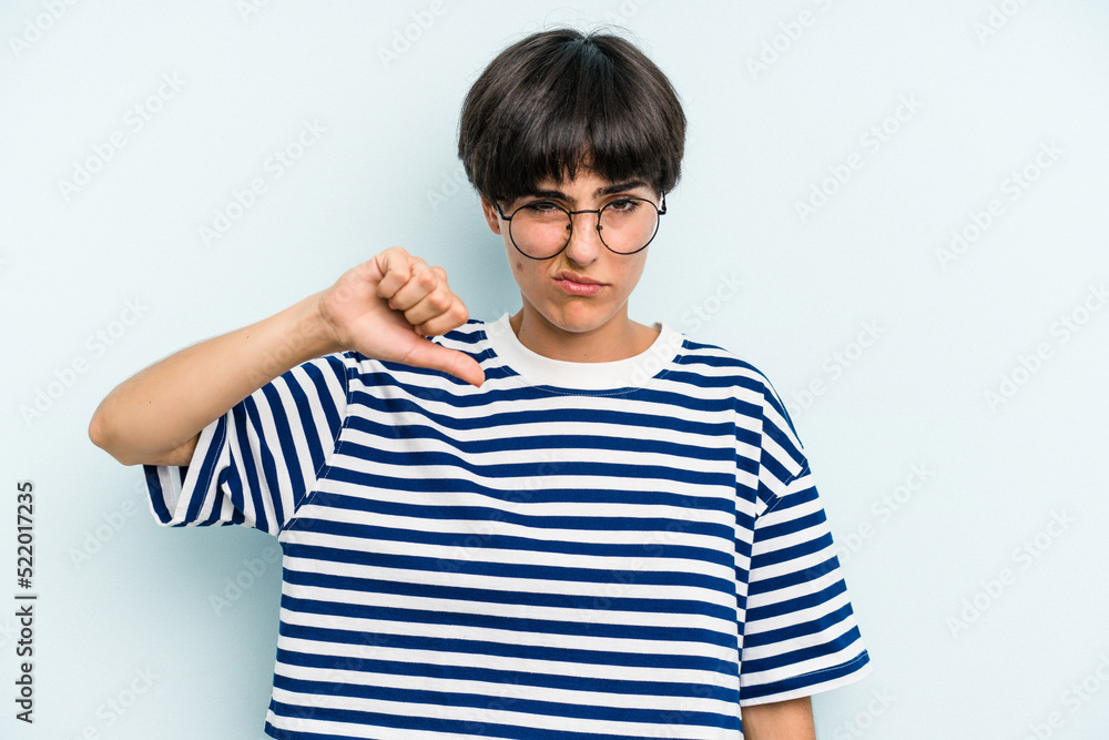 Young caucasian woman with a short hair cut isolated showing thumb down, disappointment concept. Young caucasian woman with a short hair cut isolated showing thumb down, disappointment concept.