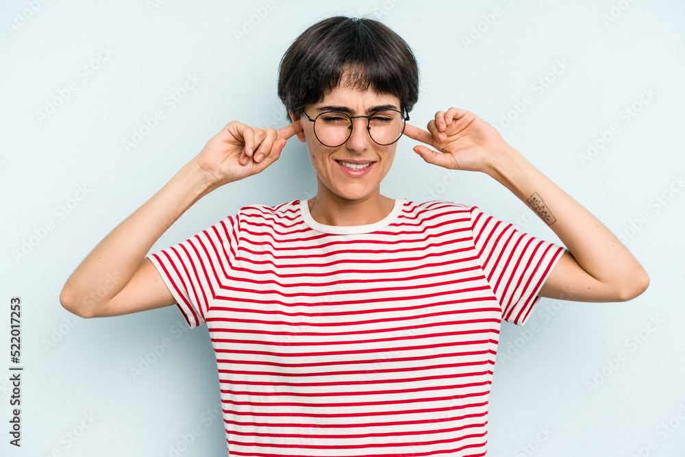 Young caucasian woman with a short hair cut isolated covering ears with fingers, stressed and desperate by a loudly ambient. Young caucasian woman with a short hair cut isolated covering ears with fingers, stressed and desperate by a loudly ambient.