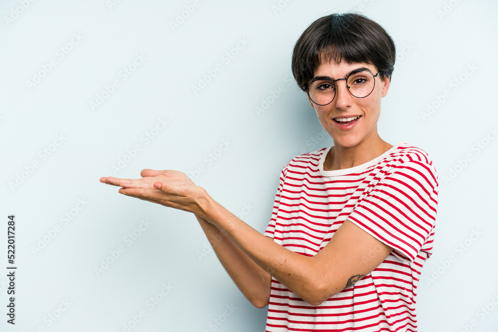 Young caucasian woman with a short hair cut isolated holding a copy space on a palm. Young caucasian woman with a short hair cut isolated holding a copy space on a palm.