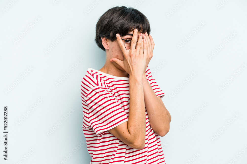 Young caucasian woman with a short hair cut isolated blink through fingers frightened and nervous. Young caucasian woman with a short hair cut isolated blink through fingers frightened and nervous.