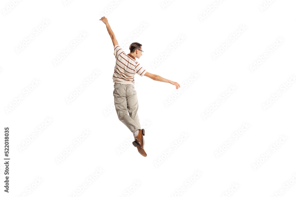 Portrait of stylish man in retro outfit posing in a jump isolated over white studio background