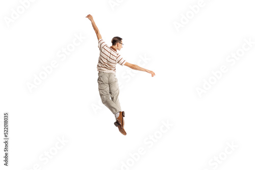Portrait of stylish man in retro outfit posing in a jump isolated over white studio background