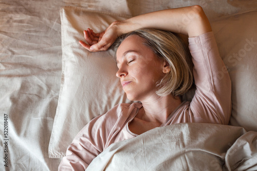 Photography Middle aged woman sleeping in cozy bed
