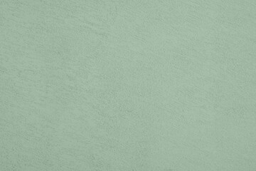 Saturated pastel gray green colored low contrast Concrete textured background. Empty colourful wall texture with copy space for text overlay and mockups. 2023, 2024 color trend