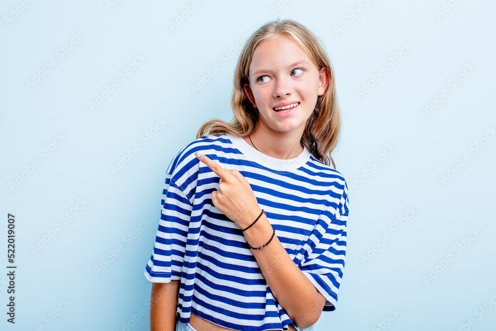 Caucasian teen girl isolated on blue background looks aside smiling, cheerful and pleasant. Caucasian teen girl isolated on blue background looks aside smiling, cheerful and pleasant.