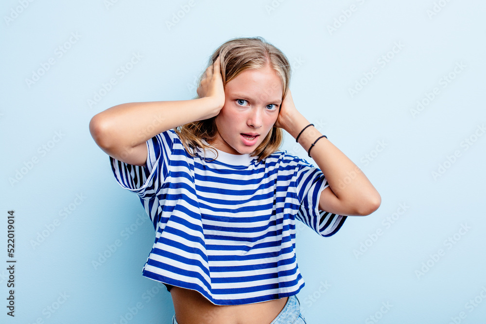 Caucasian teen girl isolated on blue background screaming, very excited, passionate, satisfied with something. Caucasian teen girl isolated on blue background screaming, very excited, passionate, satisfied with something.
