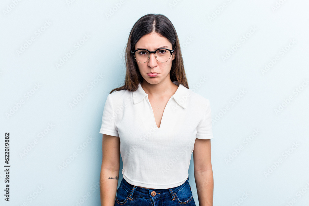 Young caucasian woman isolated on blue background sad, serious face, feeling miserable and displeased. Young caucasian woman isolated on blue background sad, serious face, feeling miserable and displeased.