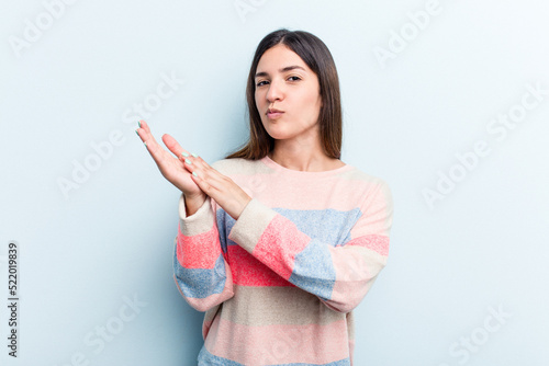 Young caucasian woman isolated on blue background feeling energetic and comfortable  rubbing hands confident.