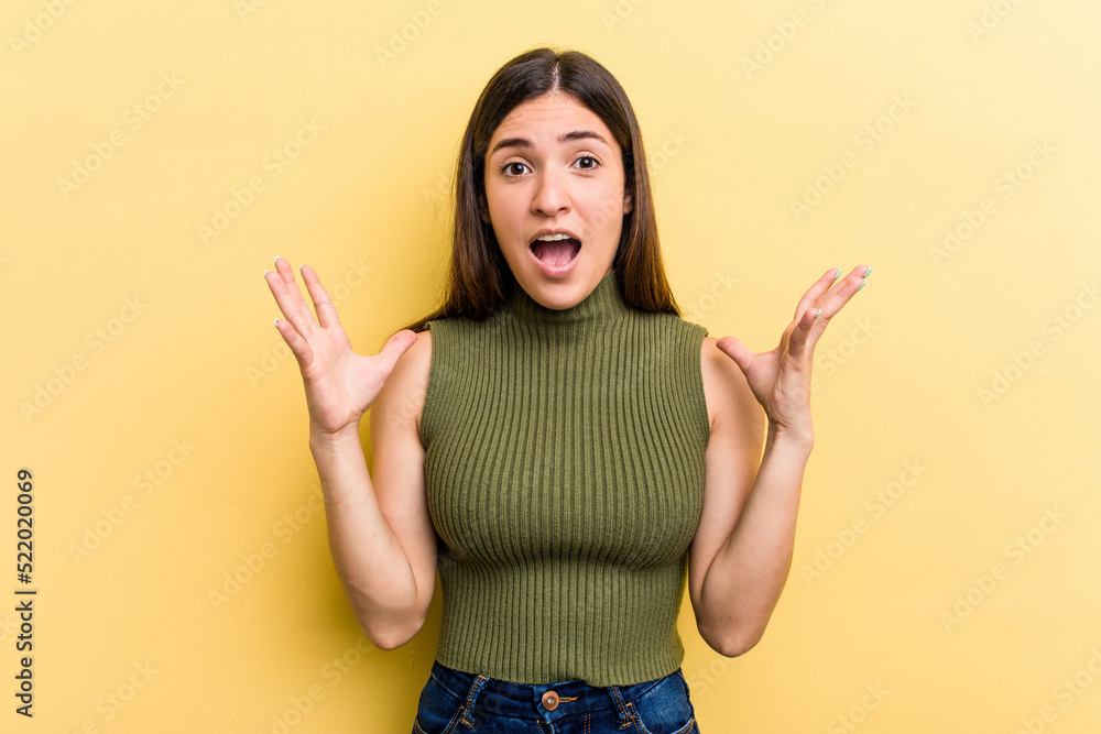 Young caucasian woman isolated on yellow background screaming to the sky, looking up, frustrated. Young caucasian woman isolated on yellow background screaming to the sky, looking up, frustrated.