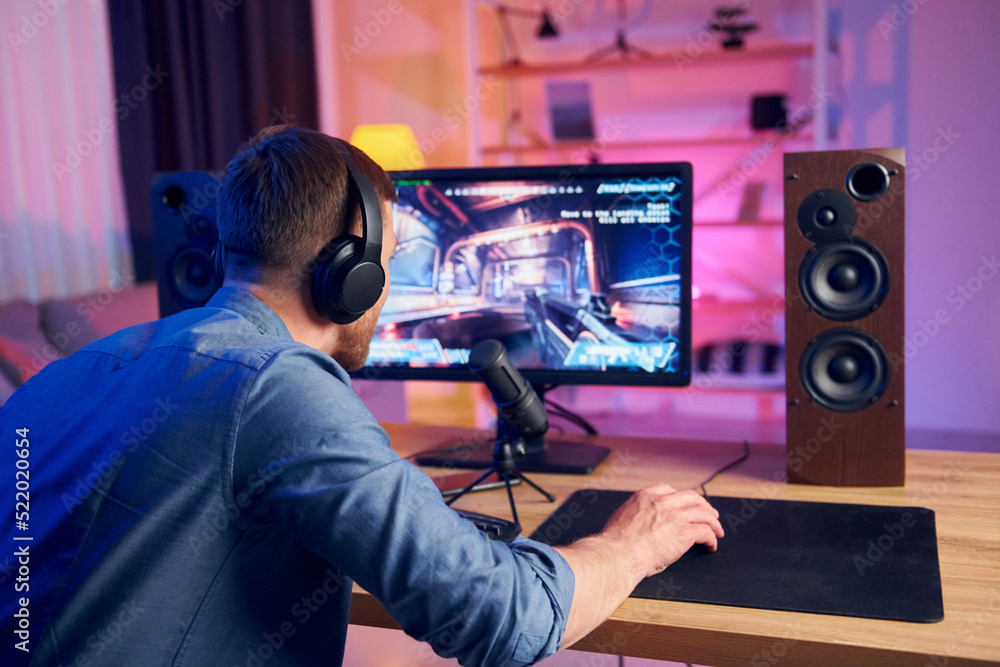 Nice gaming chair. Online streamer playing FPS shooter at home Nice gaming chair. Online streamer playing FPS shooter at home