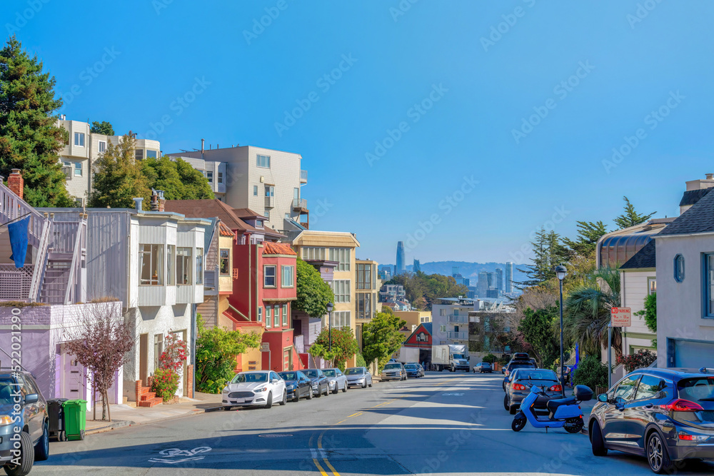Wide street on the suburban neighborhood with an overlooking view of downtown in San Francisco, CA