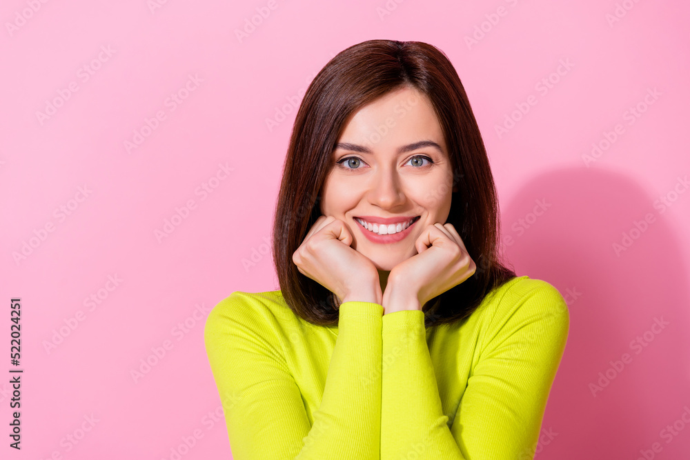 Photo of sweet shiny girl dressed lime shirt arms chin cheeks smiling empty space isolated pink color background Photo of sweet shiny girl dressed lime shirt arms chin cheeks smiling empty space isolated pink color background
