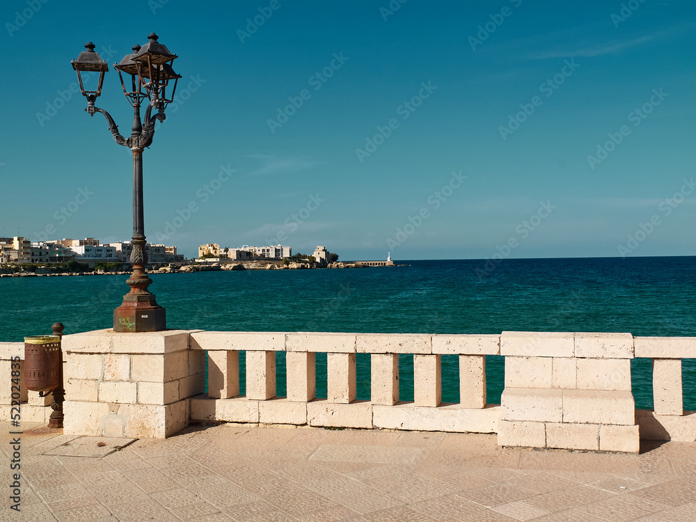 Seaside promenade in the sun in Otranto, Monumento agli Eroi e Martiri, Southern Italy, Salento, Puglia