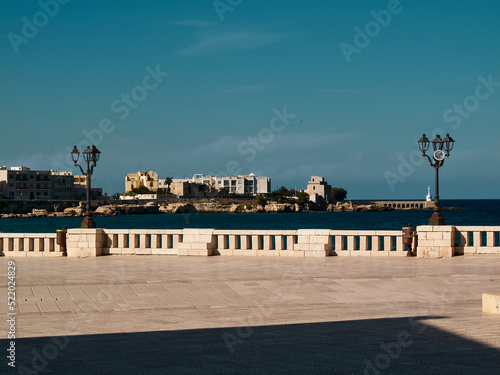 Seaside promenade in the sun in Otranto, Monumento agli Eroi e Martiri, Southern Italy, Salento, Puglia