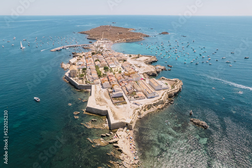 Aerial view of Tabarca island with boats at anchor. Mediterranean Sea. Popular travel destinations at summer. Spain.