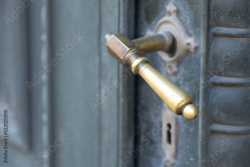 Metal decorative handles. Metal decorative handle on old massive entrance doors. © caocao191