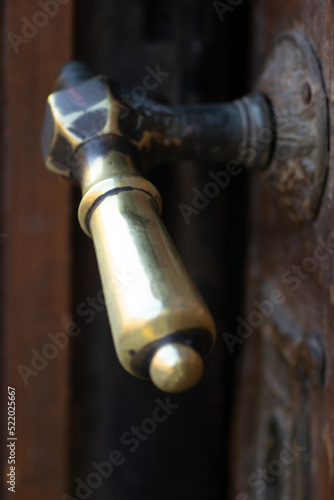 Metal decorative handles. Metal decorative handle on old massive entrance doors.