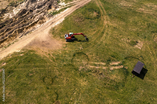 Excavator machinery on archeological site, aerial shot from drone pov