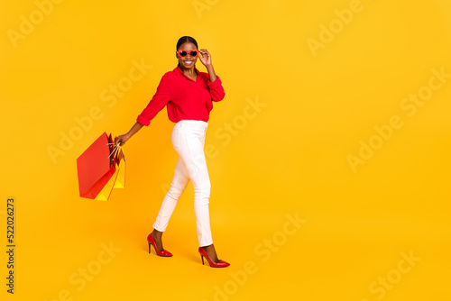 Full size profile side photo of young lovely girl go shop store eyeglasses isolated over yellow color background