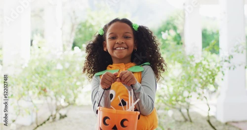 Video portrait of happy african american girl trick or treating for halloween