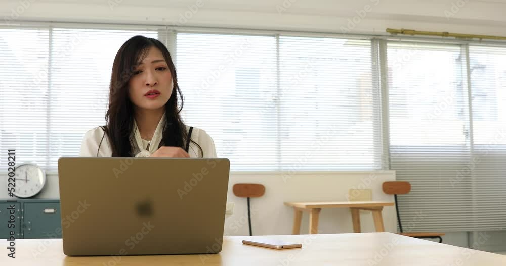 A worried Japanese woman by remote work in the small office A worried Japanese woman by remote work in the small office