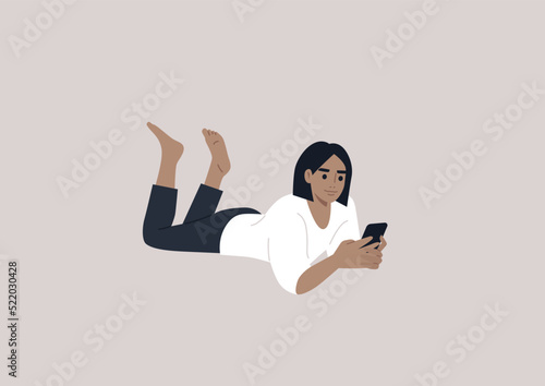 A young female Caucasian character lying on their stomach and checking their phone