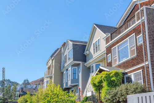 Row of houses with traditional wood sidings against the clear sky in San Francisco, California