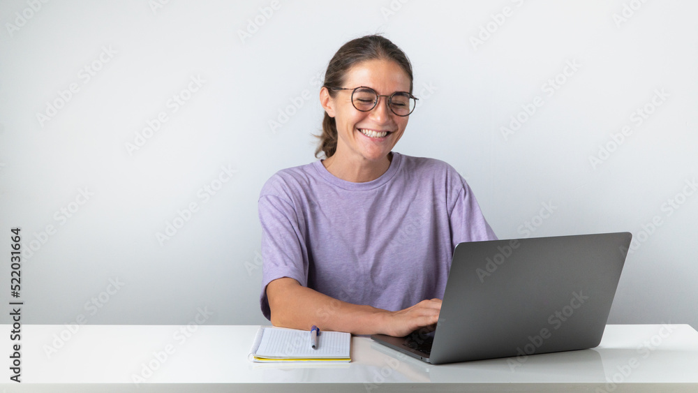 The girl at the laptop smiles, pleasant communication, good news The girl at the laptop smiles, pleasant communication, good news