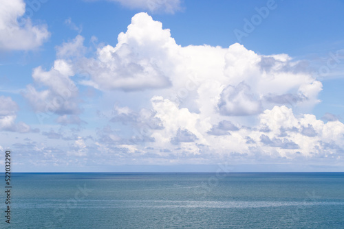 Beautiful calm turquoise color sea and blue sky with white color cloud background